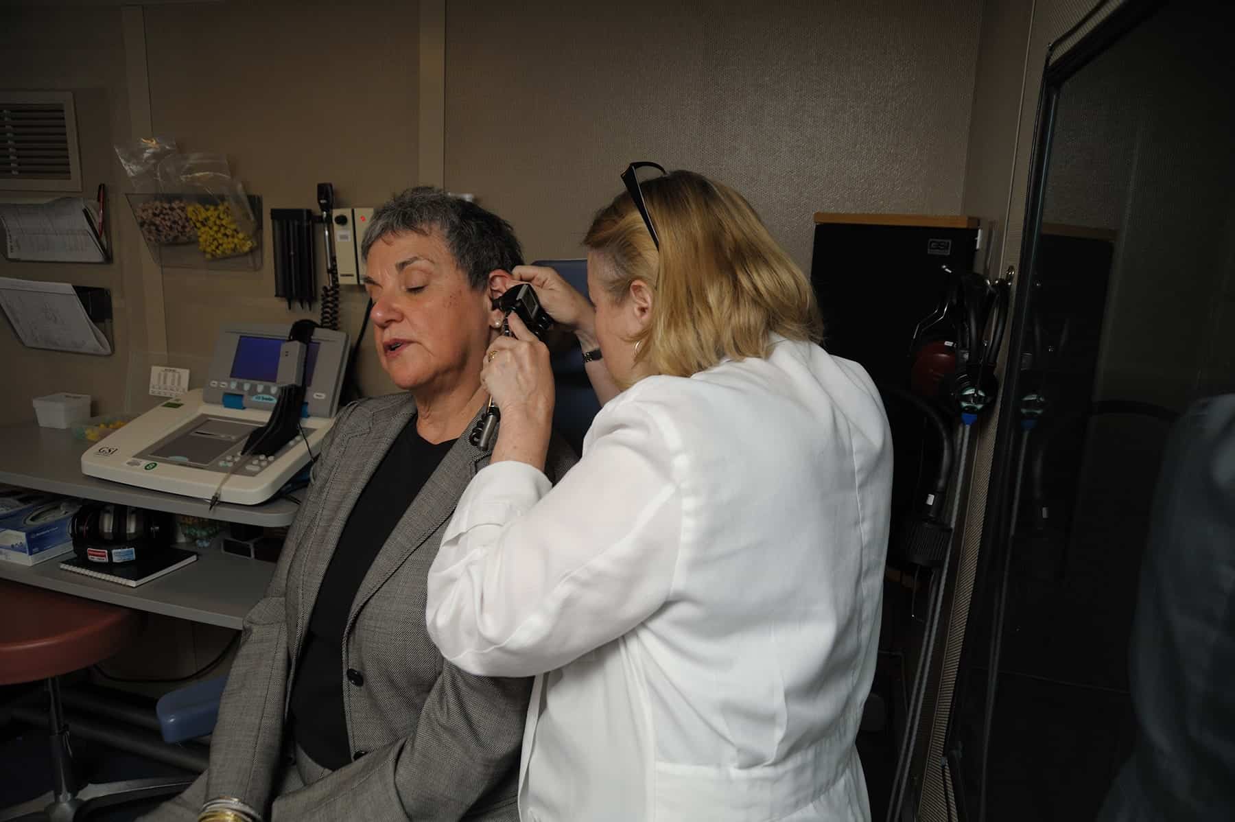 Audiologist Performing Hearing Exam on Older Female Patient