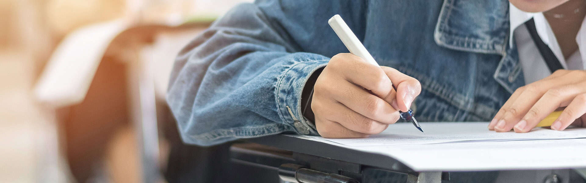 Exam with school student having a educational test / shutterstock.com