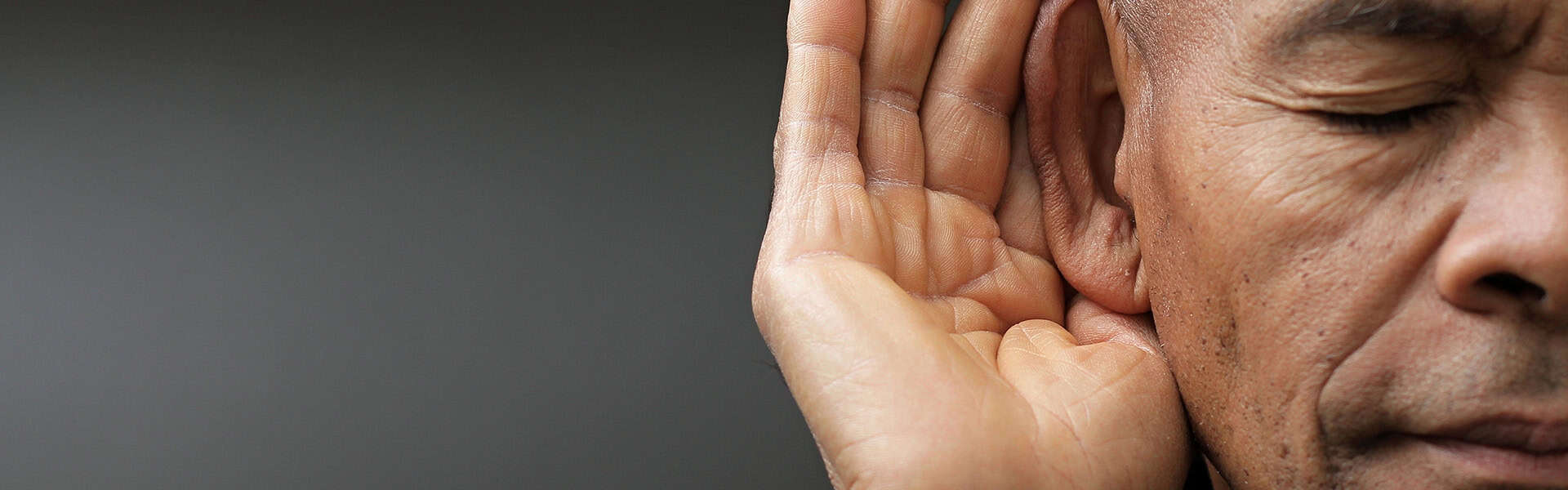 man suffering from deafness and hearing loss / shutterstock.com