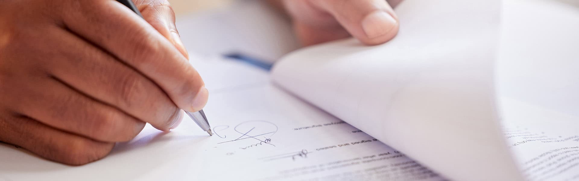 A photo of person signing a contract / shutterstock.com