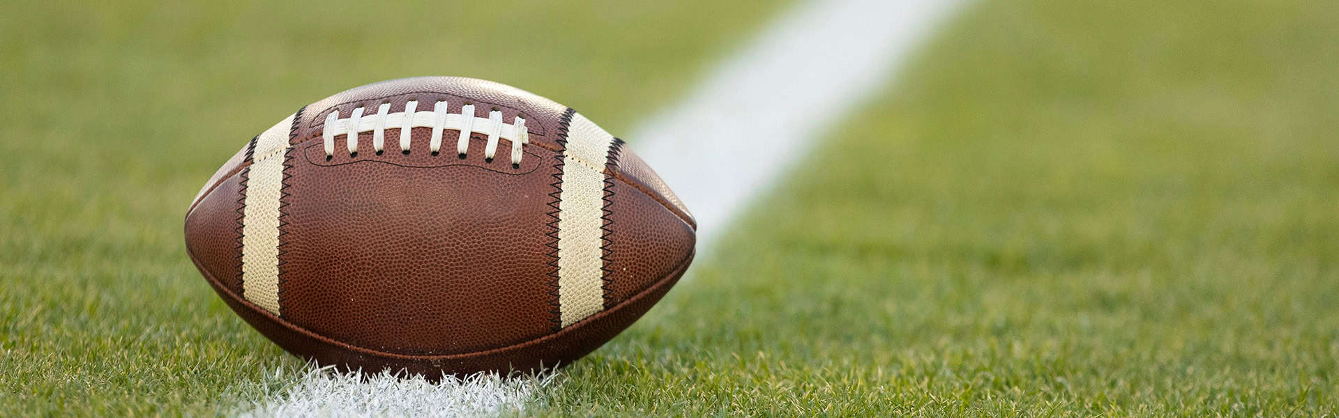 American football resting on a first down line during an American football game